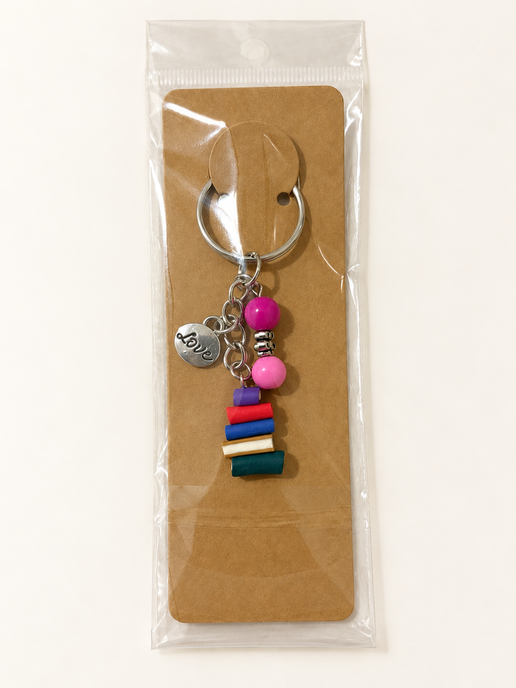 Love & Books Stack Keychain on a kraft card in a clear sleeve