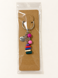 Love & Books Stack Keychain on a kraft card in a clear sleeve