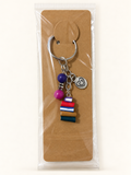 Heart & Books Stack Keychain on a kraft card in a clear sleeve