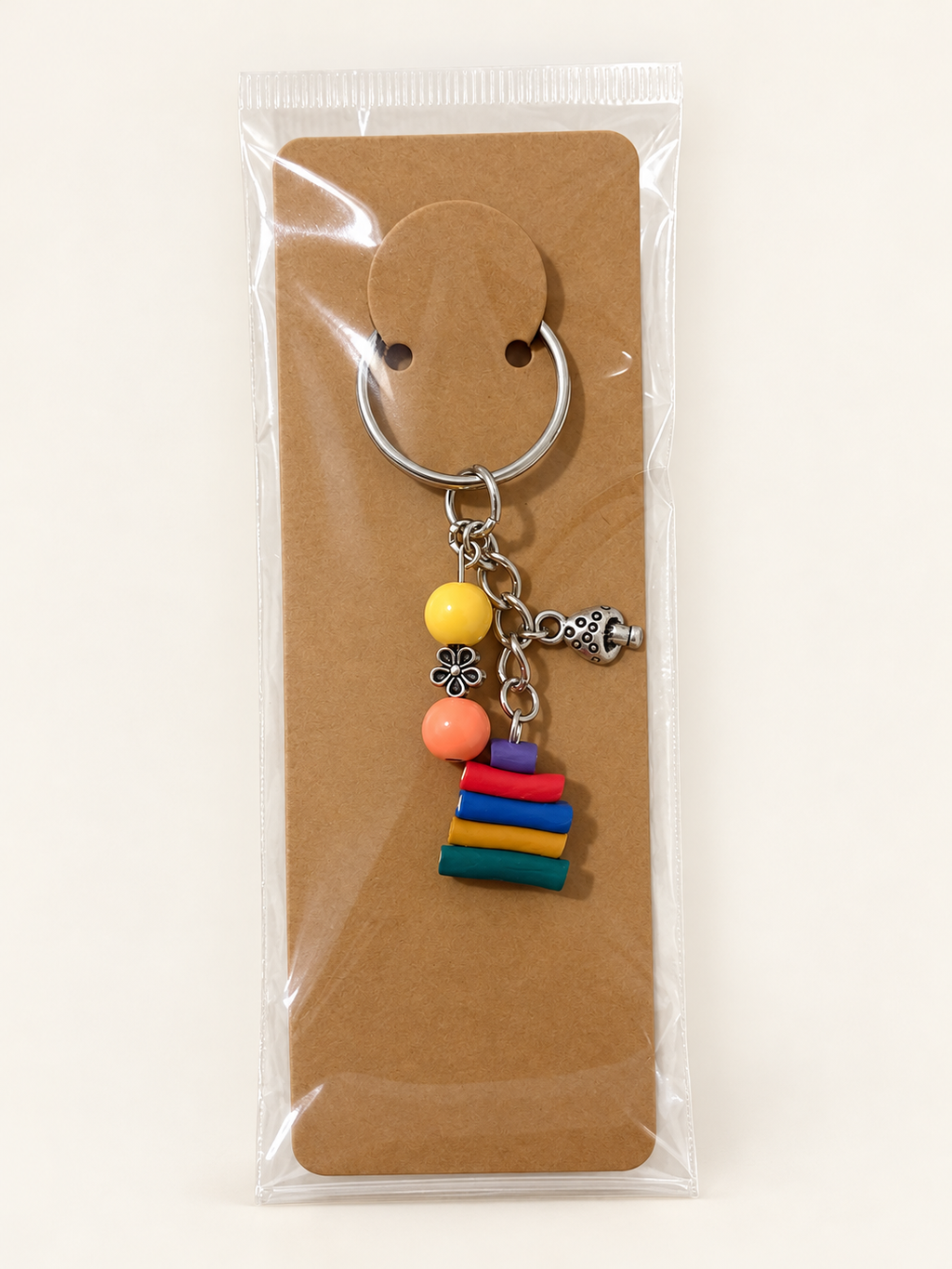 Golden Garden Book Stack Keychain on a kraft card in a clear sleeve