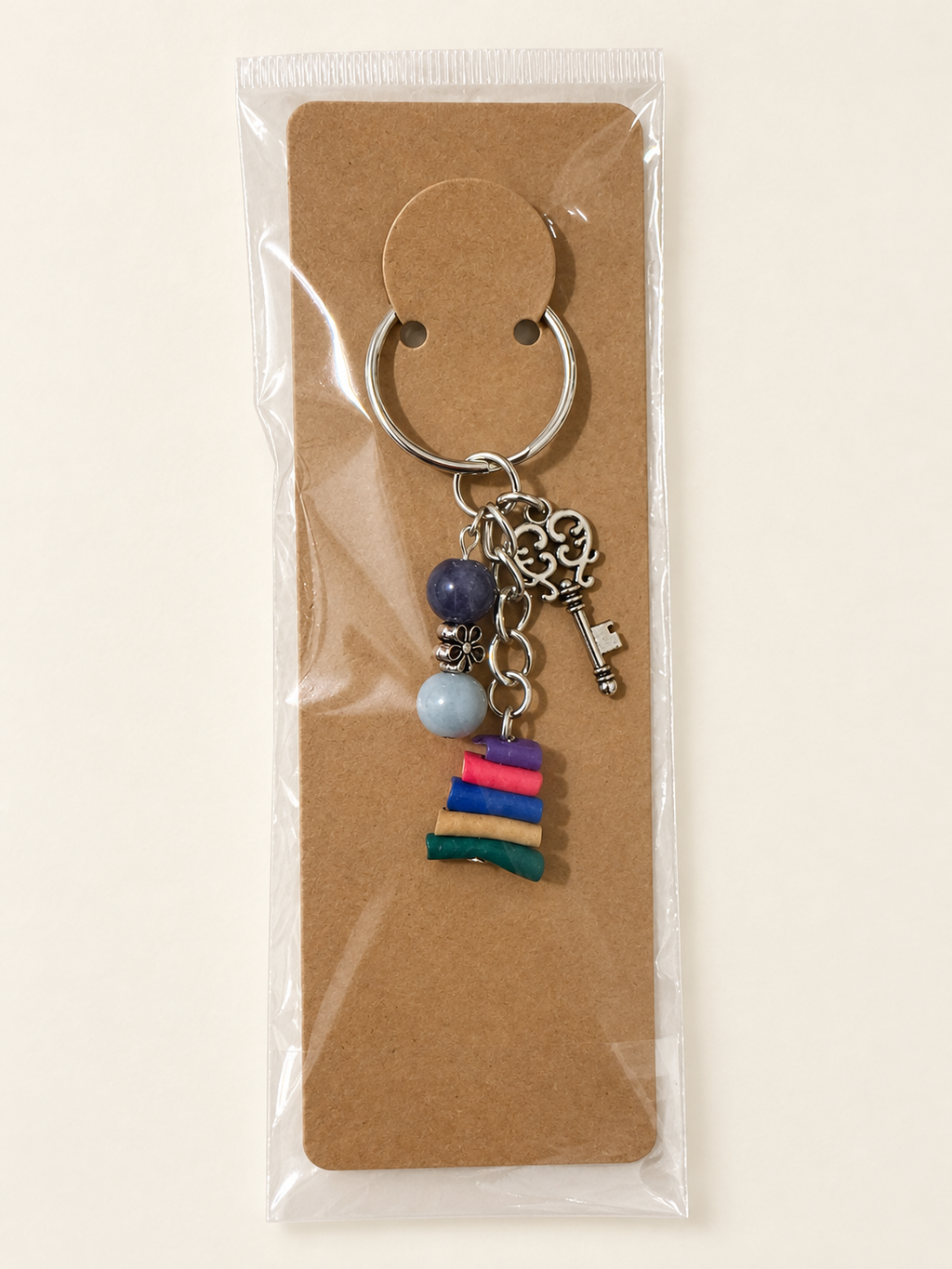 Vintage Key Book Stack Keychain on a kraft card in a clear sleeve