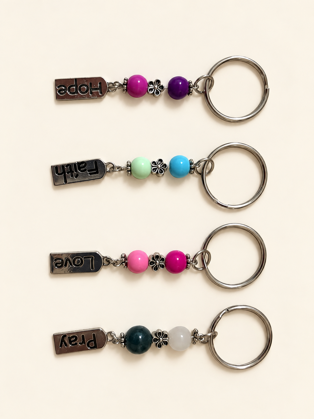 Four word keychain designs: Hope, Faith, Love and Pray; sold individually