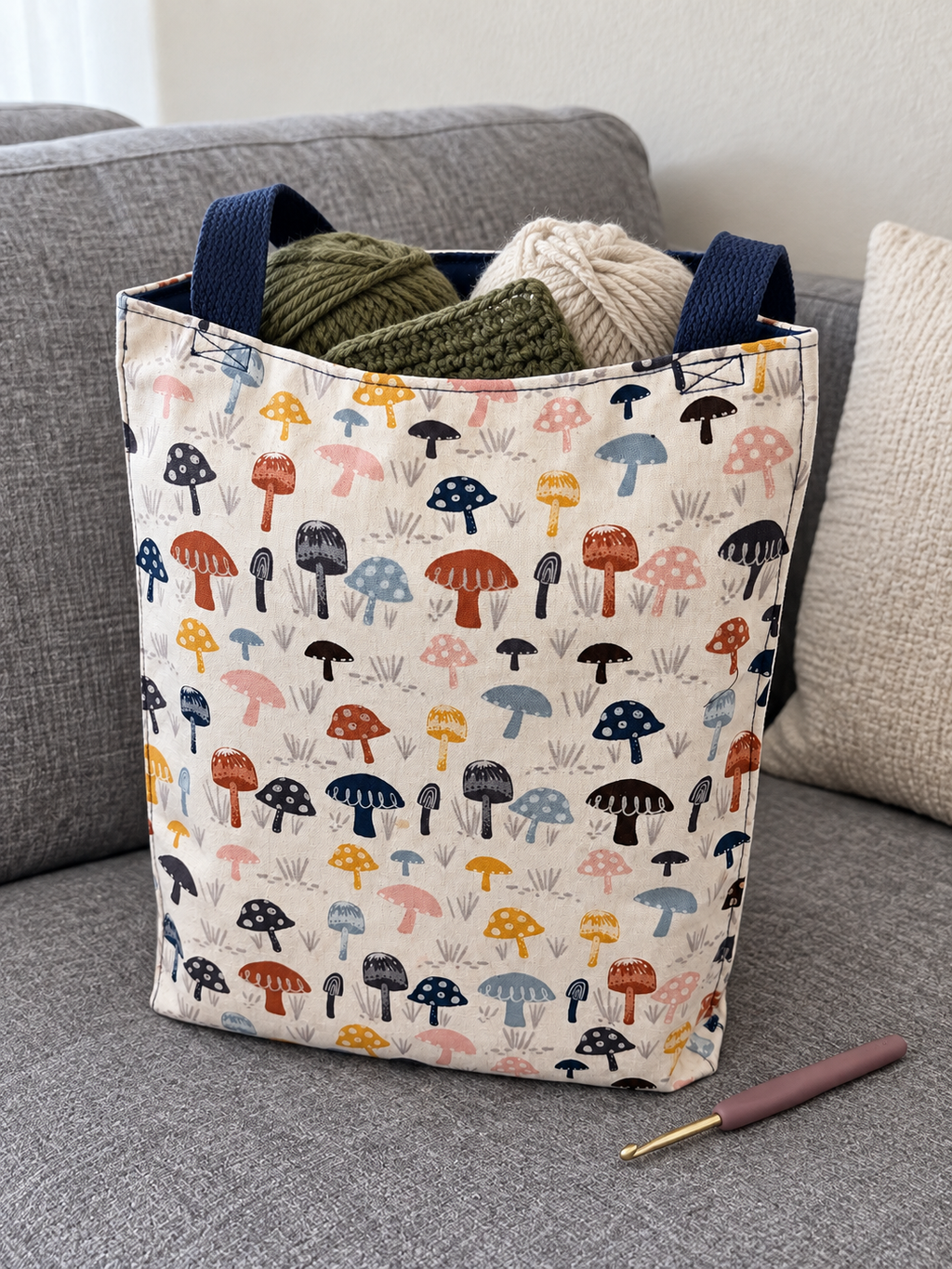 Lifestyle mockup of Mushroom Patch tote holding yarn and a crochet project