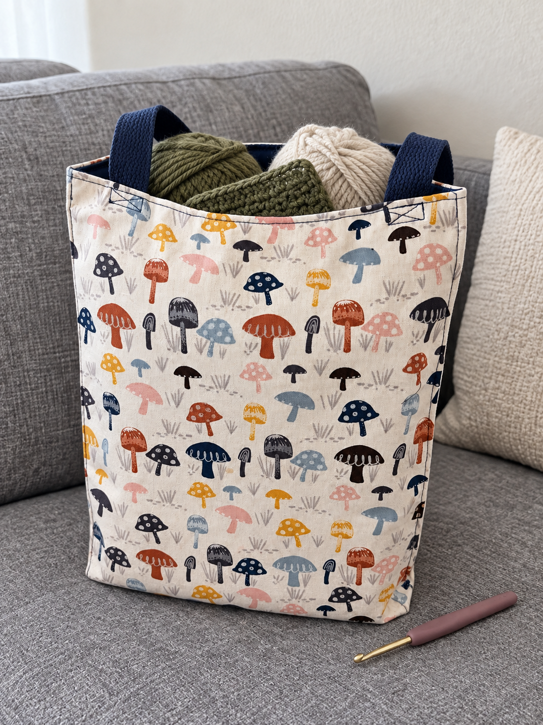 Lifestyle mockup of Mushroom Patch tote holding yarn and a crochet project